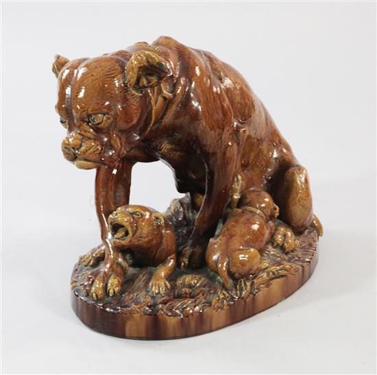 A Continental treacle glazed large stoneware group of a Boxer dog and two puppies, 46.5cm